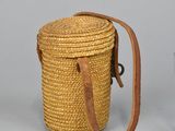 two small wicker baskets with leather straps and handles