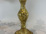 gold plated brass candelab with a floral design on the base