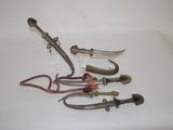 five pairs of scissors and a pair of pliers on a white surface