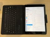 a laptop and a tablet on a desk next to each other