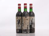 three bottles of wine sit on a table with a white background