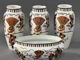 three vases and a bowl sitting on a table