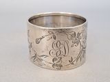 a close up of a silver ring with flowers on it
