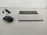 a laptop and a mouse on a white table