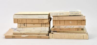 many books stacked on top of each other on a table