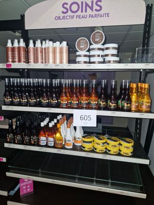 many bottles of liquid on the shelves in the store