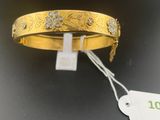 an image of a close up of a gold bracelet with a price tag