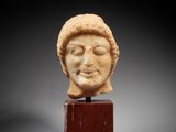 a roman marble head of a man on a wooden stand