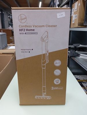packaging for a cordless vacuum cleaner on a table in a store