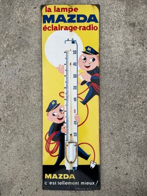 a thermometer with a picture of a man and a dog on it