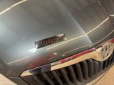 a close up of a car ' s hood with a sticker on it