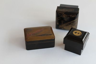 three boxes that are sitting on a white surface