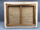 un vieux cadre photo sur lequel figure une inscription à l'intérieur