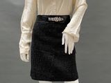 an image of a mannequin dressed in a black skirt and white blouse