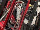 a red tool box with tools in it on the floor