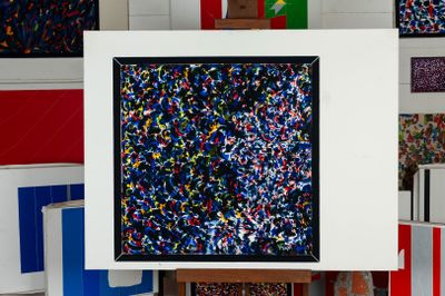 a picture of a painting on a easel in a room