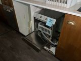 a dishwasher in the middle of a kitchen that is under the counter
