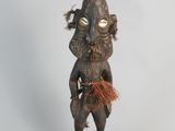 an image of a wooden statue of a man with a hat on his head