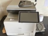 a printer sitting on top of a desk next to a printer