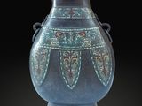 a blue vase with a design on it on a black background
