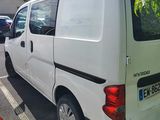 a white van parked in a parking lot next to a red fire hydrant