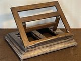 a wooden stand with two cell phones on it