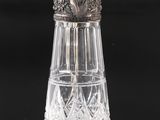 a close up of a glass salt shaker on a table