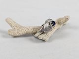 sterling silver ring with blue sapphire stone on a piece of coral