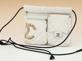 a white purse that has a gold logo on it