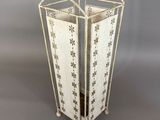 an image of a white metal planter with flowers on it