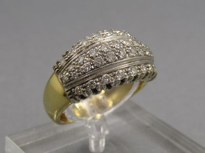 une photo d'une bague en diamant posée sur un socle transparent