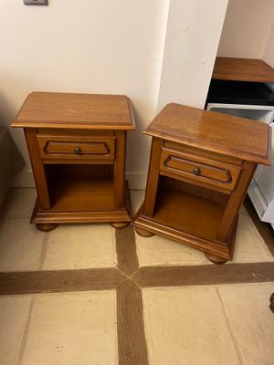 two wooden tables sitting next to each other on the floor