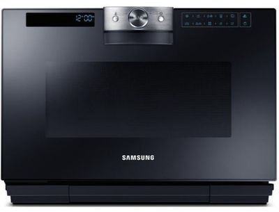 the samsung oven is built into the wall with the electronic controls