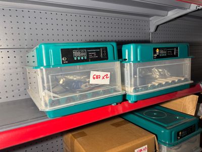 a shelf with two plastic containers on top of it