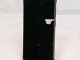 a black cell phone sitting on top of a white table