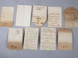 several pieces of paper with handwriting on them sitting on a table