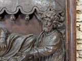 a wooden carving of a man and a woman on a bench