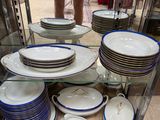 a glass display case with plates and bowls on it