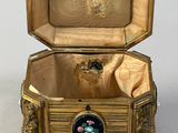 a gold box with a black and white picture inside of it