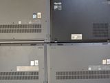 three laptops sitting on top of each other in a room
