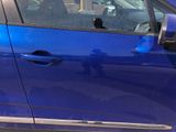 a blue car with a broken door and a broken window