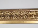 an image of a gold frame with flowers and leaves on it