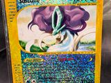 a close up of a pokemon card with a purple flower on it