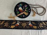 an image of a black and gold belt with a bird design on it