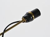 a close up of a black and gold lamp with a white background