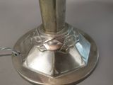 a silver lamp that is on a table