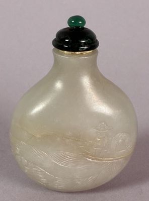 a white glass bottle with a black lid on a table