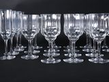 many empty wine glasses lined up on a black surface