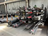 a lot of steel bars stacked on top of each other in a warehouse