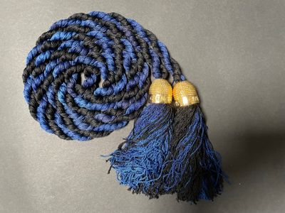 blue and black braided rope with gold beads and a blue tassel